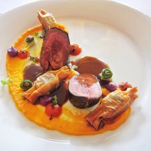 Roasted Lamb Loin wrapped with Nori, Bonbon of Lamb Shoulder Confit with Mango & Pili Nut, Purée of Bell Pepper & Ube, and Lamb Jus with Coriander.